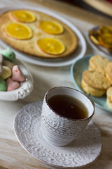 Tea with orange tarts and muffins
