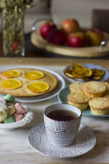 Tea with orange tarts and muffins
