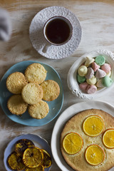 Tea with orange tarts and muffins