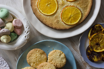 Tea with orange tarts and muffins
