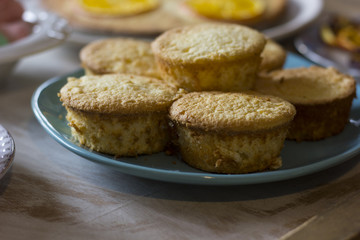 Tea with orange tarts and muffins
