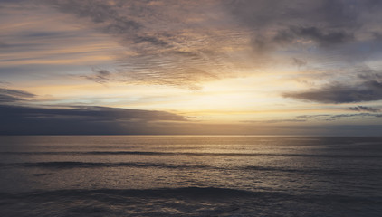 Sunlight sunset on horizon ocean on background seascape rays sunrise. Relax view waves sea on evening sand beach, sun light flare nature evening outdoor vacation concept, copy space for text.