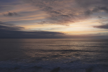Sunlight sunset on horizon ocean on background seascape rays sunrise. Relax view waves sea on evening sand beach, sun light flare nature evening outdoor vacation concept, copy space for text.