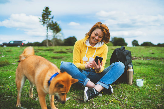 Tourist Smile Girl On Background Nature Landscape Using Mobile Smartphone With Friends Dog, Person Holding In Hands Gadget Technology, Text Message On Screen Online Wifi Internet Lifestyle Concept