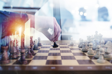 Business tactic with chess game and businessmen that work together in office. Concept of teamwork,...
