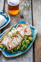 Squid served on asian salad of fresh vegetablees, copy space