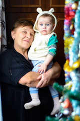 Granny with a granddaughter in anticipation of the Christmas miracle and gifts