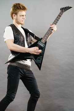 Young man playing electric guitar