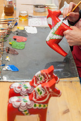 A Dalecarlian horse or Dala horse. Is a traditional carved, painted wooden horse. Mostly used as a toy for children or tourist souvenir. The red horse is  the most classic of the Swedish Dala Horse.