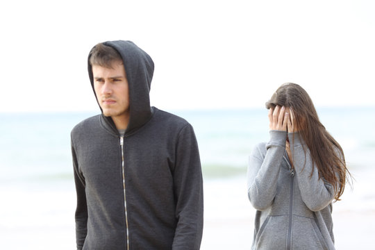 Couple break up on the beach with a man leaving girl