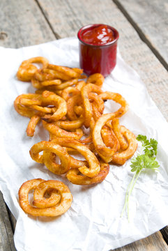 Curly fries on wood