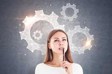 Thoughtful businesswoman, cogwheels, gray wall