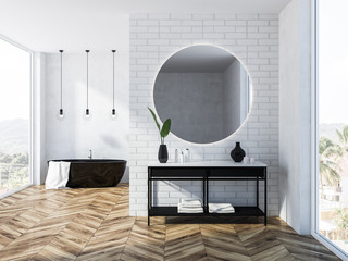 White brick bathroom interior, tub and mirror