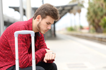Worried traveler waiting for delayed train