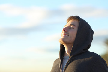 Teenage boy breathing deep fresh air