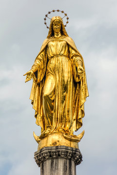 Gilded statue of Maria Immaculata on a sphere with snake and a crescent moon, sculpted by Anton Dominik Ritter von Fernkorn in 1870, placed on top of a column near Zagreb Cathedral in Zagreb, Croatia