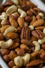 mixed nuts on wooden surface