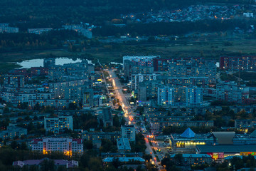 Fototapeta na wymiar Evening panorama of the city in the valley