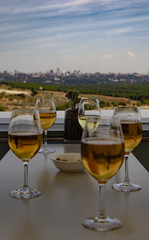 Beers in glasses on a table on the outdoor terrace with the city in the background