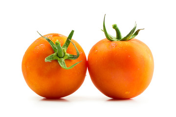 Fresh orange tomatoes isolated on white background