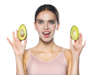 portrait of attractive young caucasian smiling cheerful woman isolated on white studio shot eating avocado lookıng at camera toothy smıle
