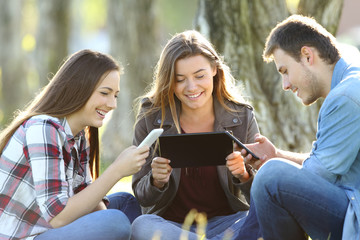 Three friends using multiple devices