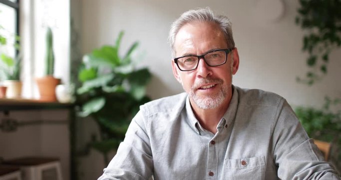 Close-up portrait of mature businessman working in a cafe