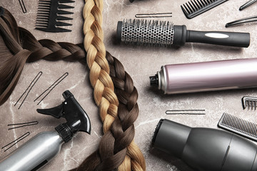 Flat lay composition with hair salon tools on grey background