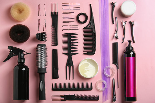 Flat lay composition with hair salon equipment on color background