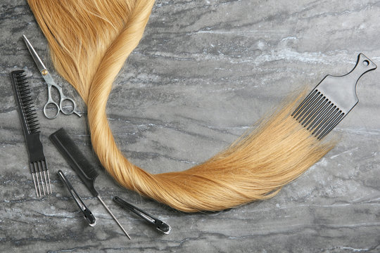 Flat lay composition with hair salon tools and space for text on grey background