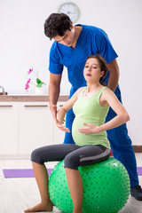 Fitness instructor helping sportsman during exercise