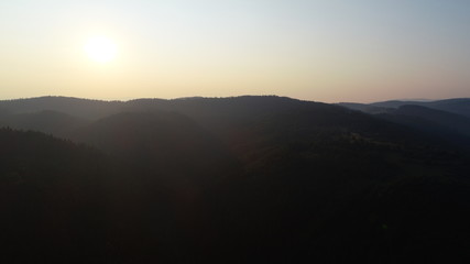 aerial view on a wild mountains  pinetree forest on beautiful sunrise