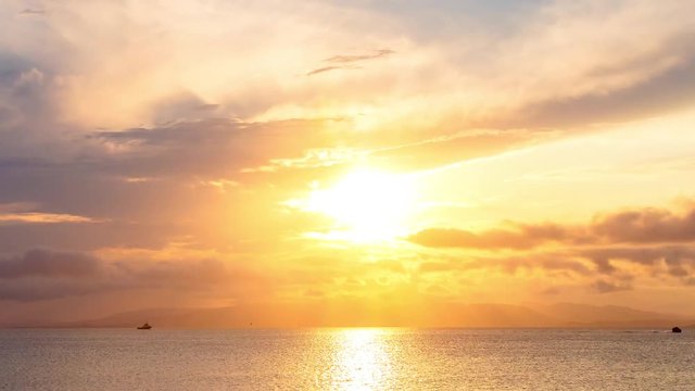 Sea view on a pleasant summer evening: a beautiful sunset, colored clouds, a pure sea with a yacht, the glint of the sun on the water. Sea, ocean, natural video for tourist, resort and meditative site