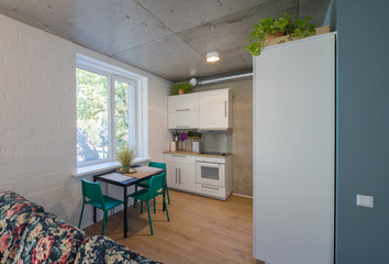 The kitchen and dining room in a modern apartment. Kitchen area in studio apartments. © Aleks Kend