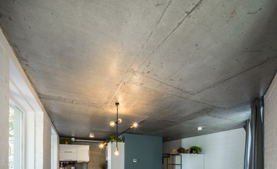 Concrete ceiling and lighting in a modern apartment. Concrete style in the apartment. © Aleks Kend