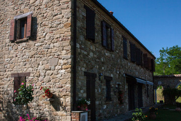 Fototapeta na wymiar Stone house with blue sky and trees background.