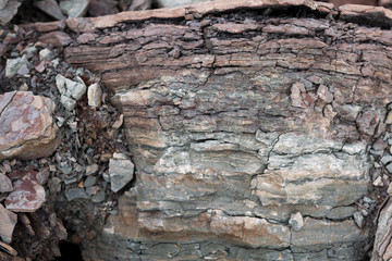 Soil cut-sandstone, stones, clay, sand structure and layers. slice of sand with layers of different structures.
