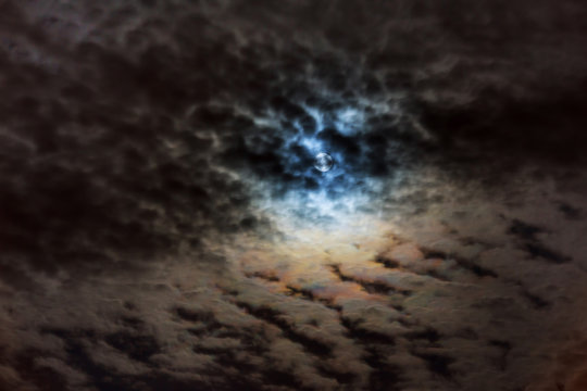 Mysterious night sky with full moon. Dramatic clouds in the moonlight from full moon.