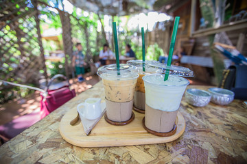 The background of the drink, (coffee, fresh milk, nectar). The back has a view of the mountains, green fields, view wooden bridge, beautiful natural and relax during the holiday.
