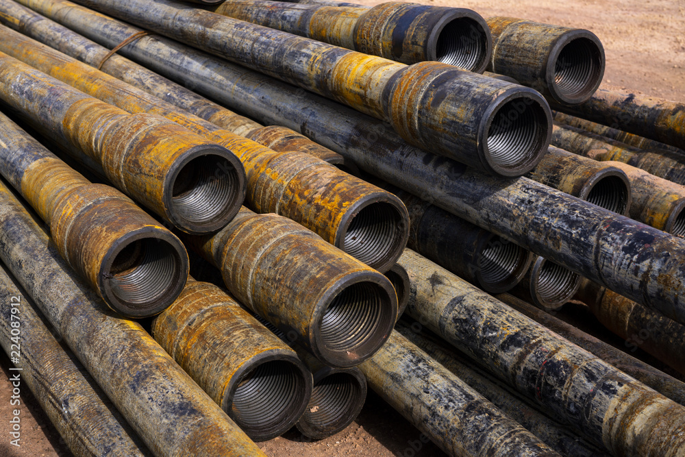 Wall mural oil drill pipe. rusty drill pipes were drilled in the well section. downhole drilling rig. laying th