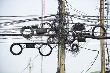 Wire assemblage a lot of cables and wires on pole in the city
