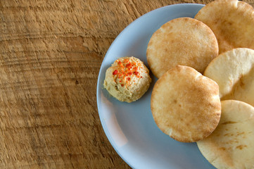 Tasty Mini Pita Bread with Humus on Rustic Wood