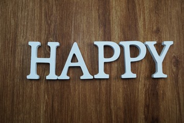 happy alphabet letters top view on wooden background