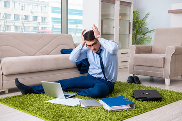 Businessman taking work home and working overtime