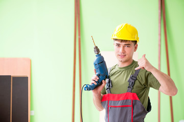 Young man carpenter working in workshop 