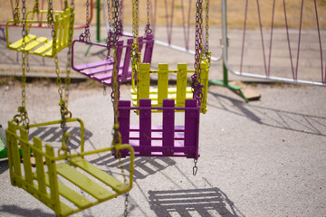 Empty rusting carousel seat at the closed amusement park.