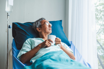 Lonely old asian patient on patient bed in hospital - Powered by Adobe