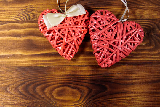 Two pink hearts on wooden background