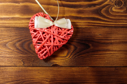 Pink heart on wooden background