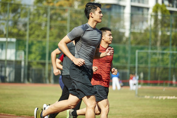 young asian athletes running on track © imtmphoto